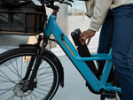 A person removing a safe shield battery from an ebike
