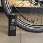 Rad Portable Tire Inflator shown inflating a bicycle tire to 30 PSI. 