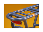 A blue electric bike rack and red taillight against a gold background.