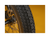 Close up of an ebike tire tread pattern against a gold background.